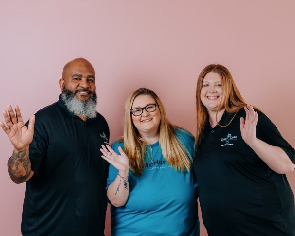 Three McHur Care team members waving